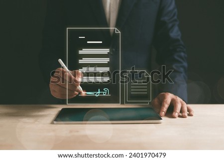Electronic Signature Concept, Electronic Signing. Businessman using stylus pen signs electronic documents on digital documents on virtual laptop screen.