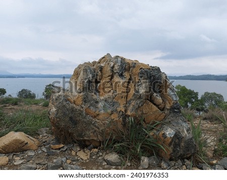 Big rock and the lake at Bukit Batu Riam Kanan, Banjar, South Kalimantan, Indonesia Royalty-Free Stock Photo #2401976353