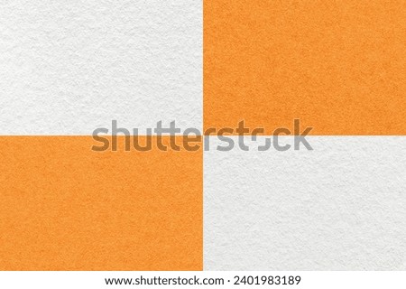 Texture of craft white and orange paper background with cells pattern, macro. Structure of vintage dense kraft ginger cardboard. Felt abstract checkered backdrop closeup.