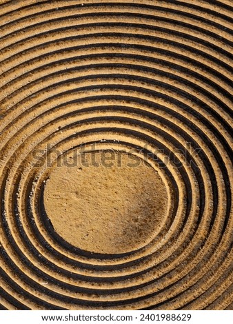 Rusty golden brown color of man hole cover. Abstract vertigo, background. Round shapes. Pattern and texture.