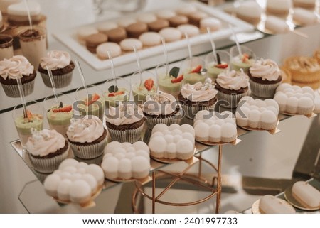 Almond cookies and various sweet cakes for a wedding banquet. A delicious reception, a luxurious ceremony. Table with sweets and desserts. Delicious colorful French desserts on a plate or table.