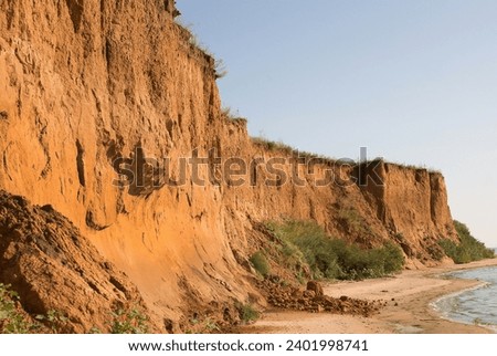 Geography. Geology. 30-meter clay cliffs on the banks of the Dnieper-Bug freshwater estuary as a result of current water erosion and the ancient Ozolimna sea reservoir, marine transgression Royalty-Free Stock Photo #2401998741