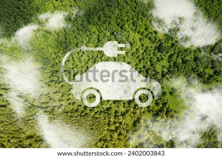 Aerial top down of white electric car driving with sustainable car icon. Graphic.