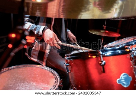 Close-up of male hands playing the drums.
