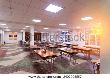 Cafeteria, dining room in university, cafe with tables and chairs, counter bar hotel. Royalty-Free Stock Photo #2402006557