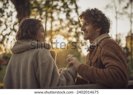Happy loving couple enjoying their time together in park. Royalty-Free Stock Photo #2402014675