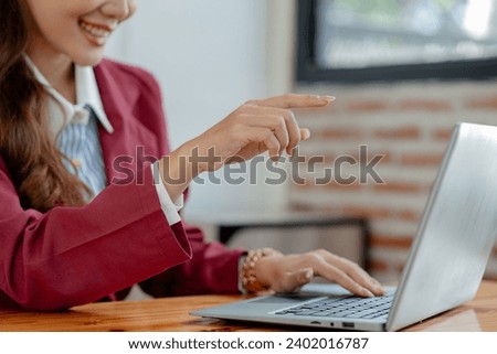 Businesswoman is sitting and working in the office, Employee is looking for information on laptop, Recording various information on paper, Employees sit and take notes in the office.