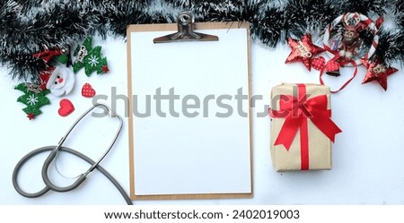 Christmas banner with decorated green fir branches ,Santa Claus, reindeer ,Christmas trees and
Clipboard, stethoscope, glasses, pen, gift box, ornaments isolate on a white backdrop.