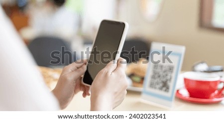 Woman use smartphone to scan QR code for order menu in cafe restaurant with a digital delivery. Choose menu and order accumulate discount. E wallet, technology, pay online, credit card, bank app.