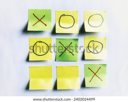 tic tac toe game on sticky notes, bright light isolated on white background Royalty-Free Stock Photo #2402024499