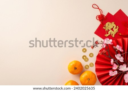 Welcome Chinese New Year in grandeur with visually appealing arrangement. Top view of fan, Feng Shui items, traditional coins, decorative elements on white, providing space for celebratory message