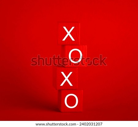 Stack of red wooden cubes with letters x and o on red background. Valentine's Day card. Royalty-Free Stock Photo #2402031207