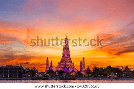 Wat Arun Ratchawararam Ratchawaramahawihan at sunset in bangkok Thailand. Landmark of Along the Chao Phraya River Thailand Royalty-Free Stock Photo #2402036163