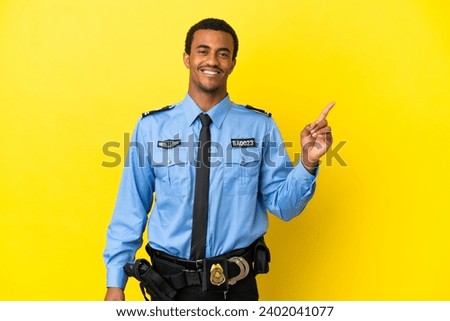 African American police man over isolated yellow background showing and lifting a finger in sign of the best