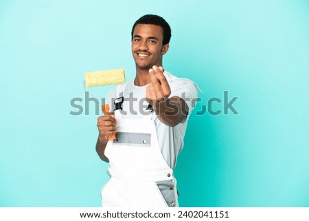African American painter man over isolated blue background making money gesture