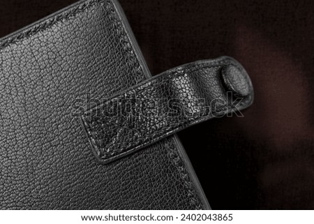 Part of a purse or purse made of black genuine leather.