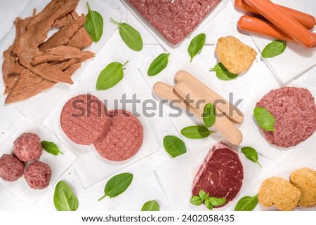 Green meat, various vegan plant based meat alternatives in different kinds – steak, minced meat, burger cutlet, nuggets, hot dog sausages, meatballs, strips Royalty-Free Stock Photo #2402058435