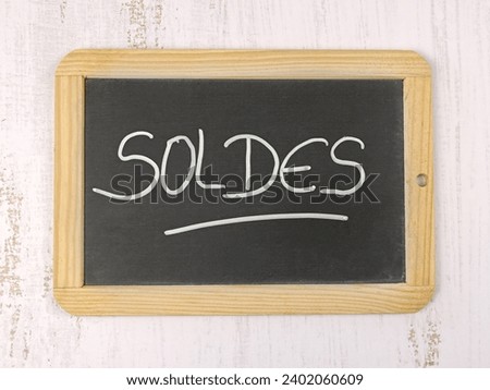 the word "clearance sale" written in French on a slate