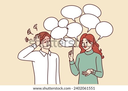 Chatty woman irritates man clutches head and does not want to listen to girl standing among speech bubbles. Guy is experiencing tension and discomfort due to chatty girlfriend spreading gossip. Royalty-Free Stock Photo #2402061551
