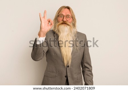 cool senior man feeling happy, showing approval with okay gesture. crazy teacher concept