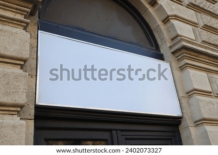 Blank billboard sign mockup in the urban environment on old building, facade, empty space to display your advertising or branding campaign