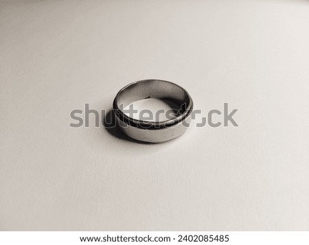 a silver ring photographed on a white background