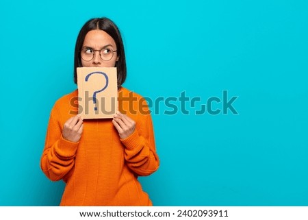 young latin pretty woman holding a placard with a concept 