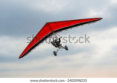 Red wing hang glider trike silhouette Royalty-Free Stock Photo #2402098233