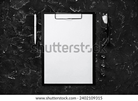 Blank stationery template. Clipboard, blank letterhead, pen and glasses. Flat lay. Royalty-Free Stock Photo #2402109315