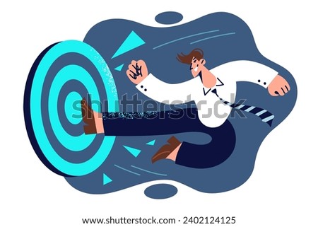 Successful business man breaks target with foot, demonstrating determination and ambition to achieve results. Manager with ambition hits precisely in aim, wanting to reach progress in management Royalty-Free Stock Photo #2402124125