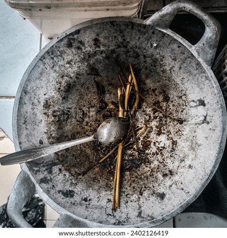 A used cooking pan, stained and soiled after cooking Royalty-Free Stock Photo #2402126419