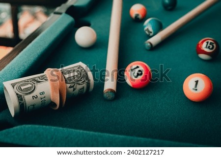 Gambling addiction.Money dollars on the game of snooker, sports betting, dollars.gambling addiction concept.Toned. Royalty-Free Stock Photo #2402127217