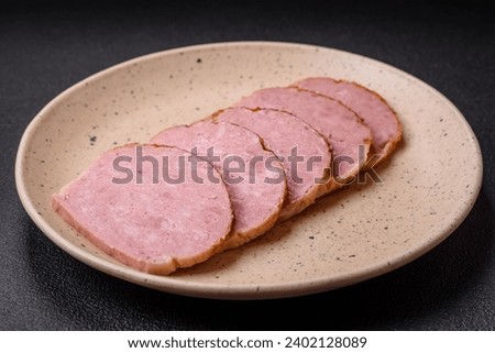 Delicious baked chicken or turkey meat roll with salt and spices on a textured concrete background
