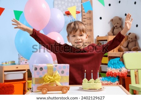Cute little boy with cake celebrating Birthday at home Royalty-Free Stock Photo #2402129627