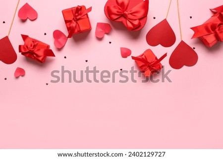 Gift boxes with paper hearts and confetti on pink background. Valentine's Day celebration