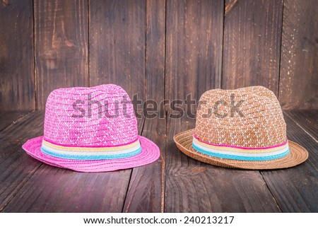 Beach hat on wooden background - vintage dark style pictures