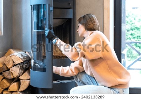 Young woman cleaning fireplace. Preparation for cold winter	