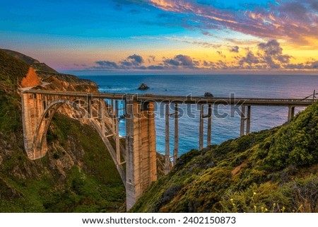 Bixby Bridge also known as Rocky Creek Bridge and Pacific Coast Highway at sunset near Big Sur in California, USA. Royalty-Free Stock Photo #2402150873