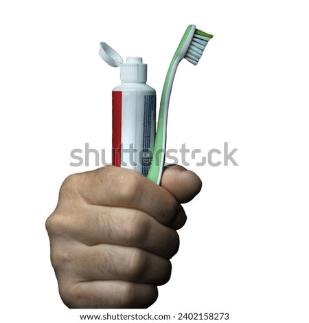 a man with a toothbrush and a tube of toothpaste in his hand