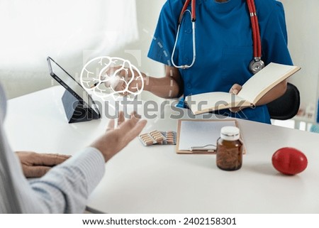 A young man is consulting with a psychiatrist while a patient undergoes psychiatric counseling by a doctor taking notes at the clinic. Encouragement, therapy, medical health concept Close-up pictures