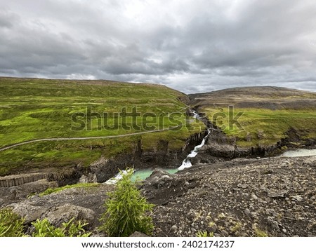 Aerial view on icelandic landscape with green grass and canyon
