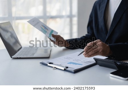Accountant holding documents preparing performance analysis report Executives create documents at work using online computer software for analyzing financial data. Close-up pictures