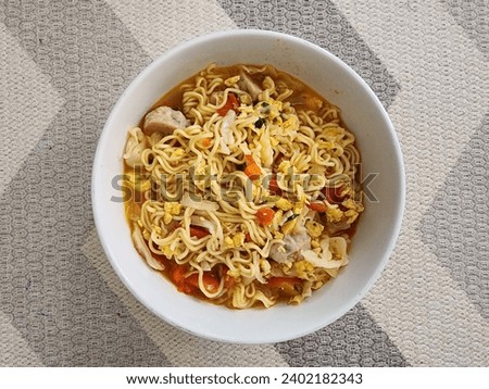 spicy noodle soup with chili, tomato, cabbage, and some chicken meatball