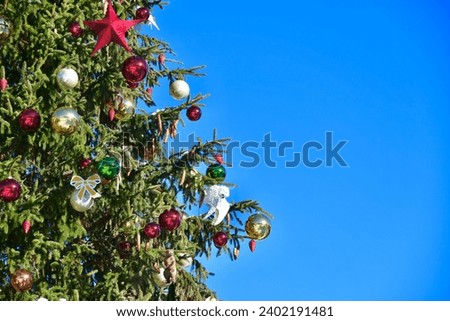Decorated Christmas tree with blue sky background 