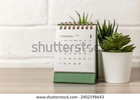 Desk calendar for February 2024 and on the table with copy space Royalty-Free Stock Photo #2402198643