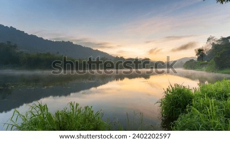 Start your day with nature’s morning symphony in this royalty-free image of a serene lake at sunrise. The calm waters and lush greenery create a harmo