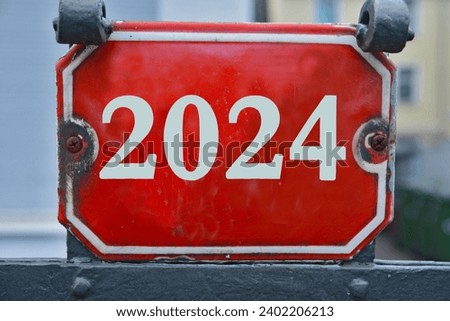 A red house number plaque, showing the number two thousand twenty four (number 2024); new year
