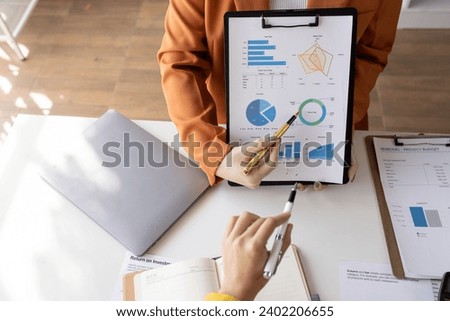 business women working on desk office with using a calculator to calculate the numbers tax, finance accountingresearch or financial strategy in company concept