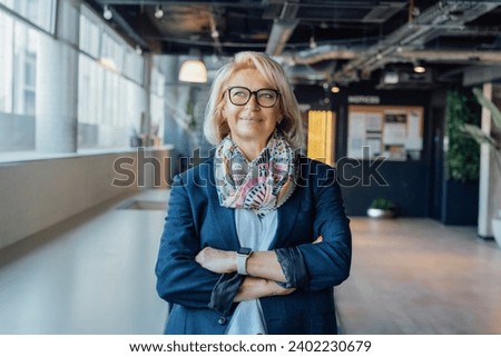 Portrait of smiling 50's stylish, confident mature businesswoman, middle aged company ceo director, experienced senior female professional, business coach team leader in modern office. Female leader. Royalty-Free Stock Photo #2402230679