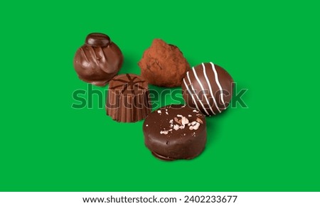 Chocolate candies collection. Beautiful Belgian truffles isolated on green screen 